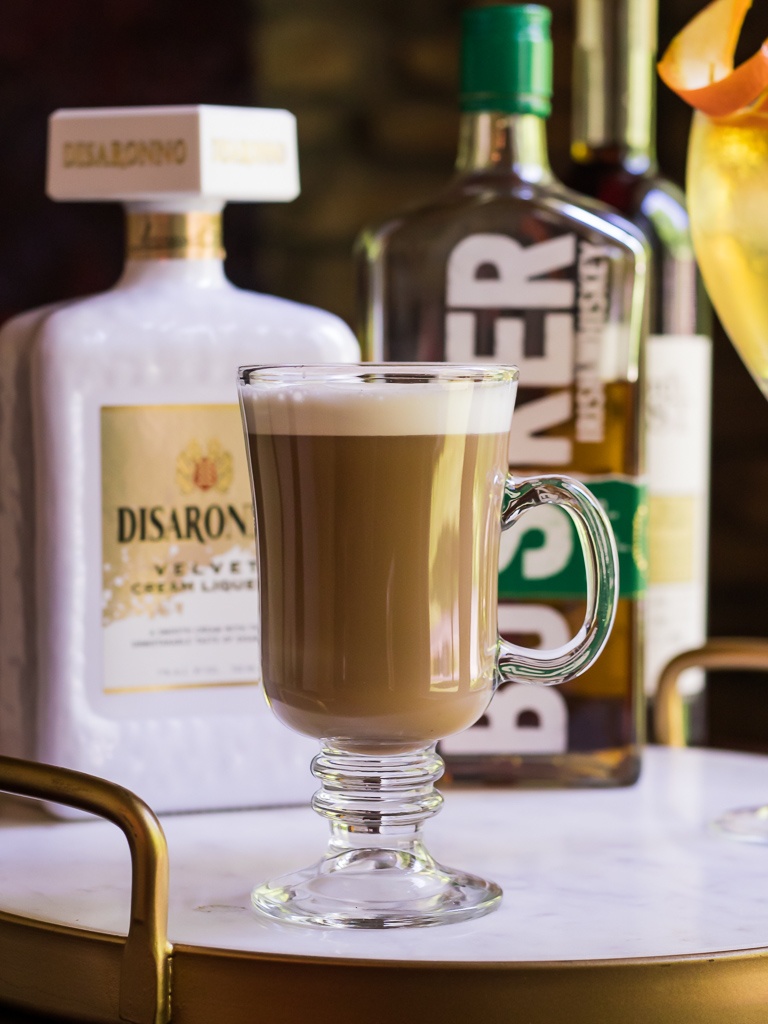 Irish coffee riff with two bottles of spirits behind.