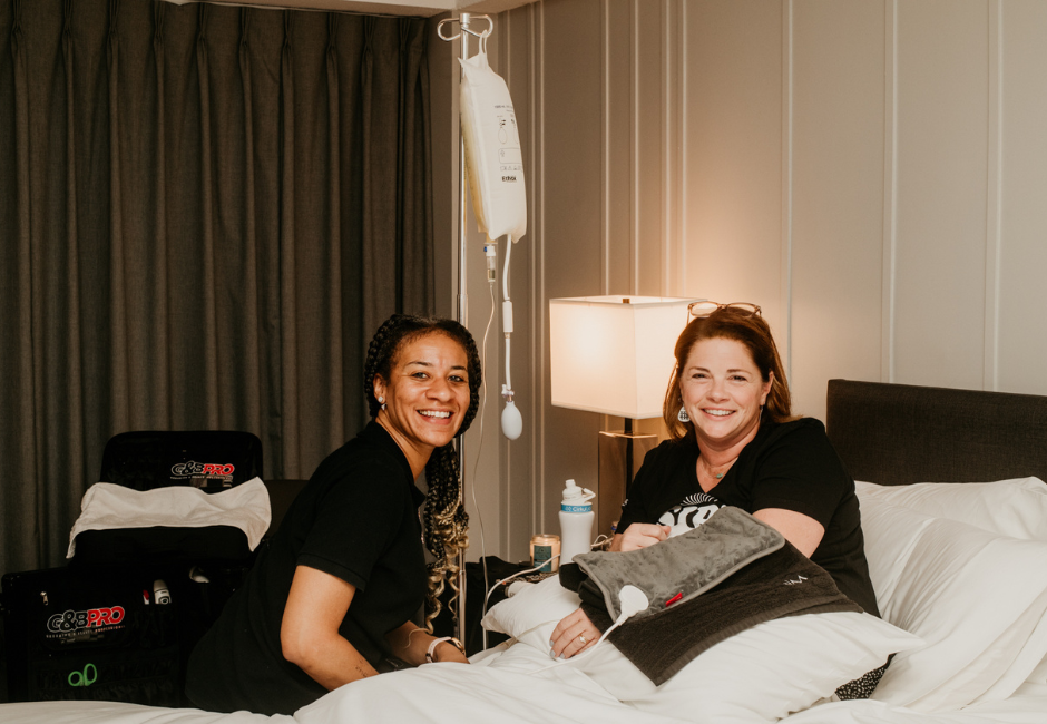two women in a room with and an IV for mobile hydration